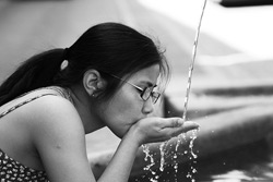 woman drinking from fountain